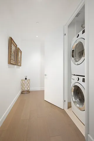 a kitchen with stainless steel appliances a stove a refrigerator and a refrigerator with wooden floor