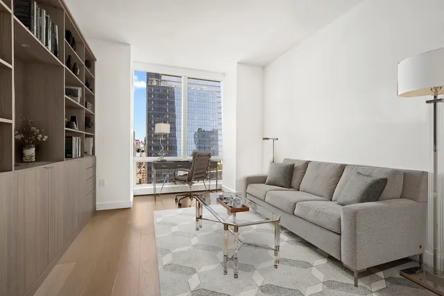 a living room with furniture and large windows