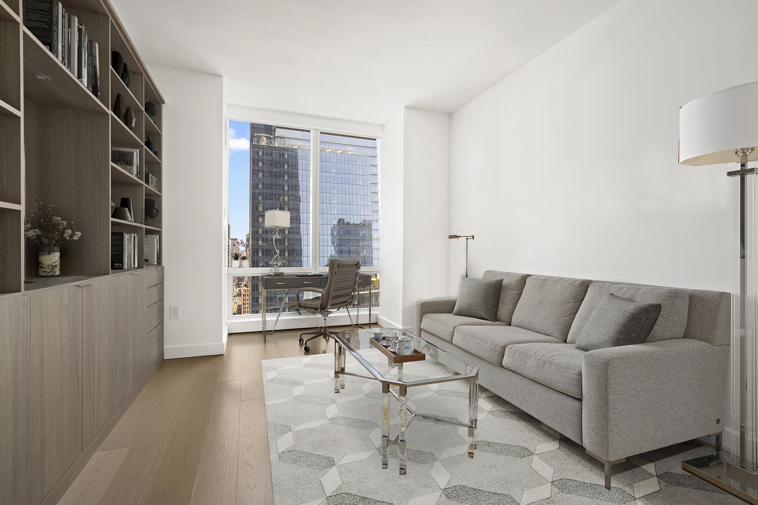 15 Hudson Yards, Unit 33H Manhattan, NY 10001 - Photo 7 of 10 a living room with furniture and a large window