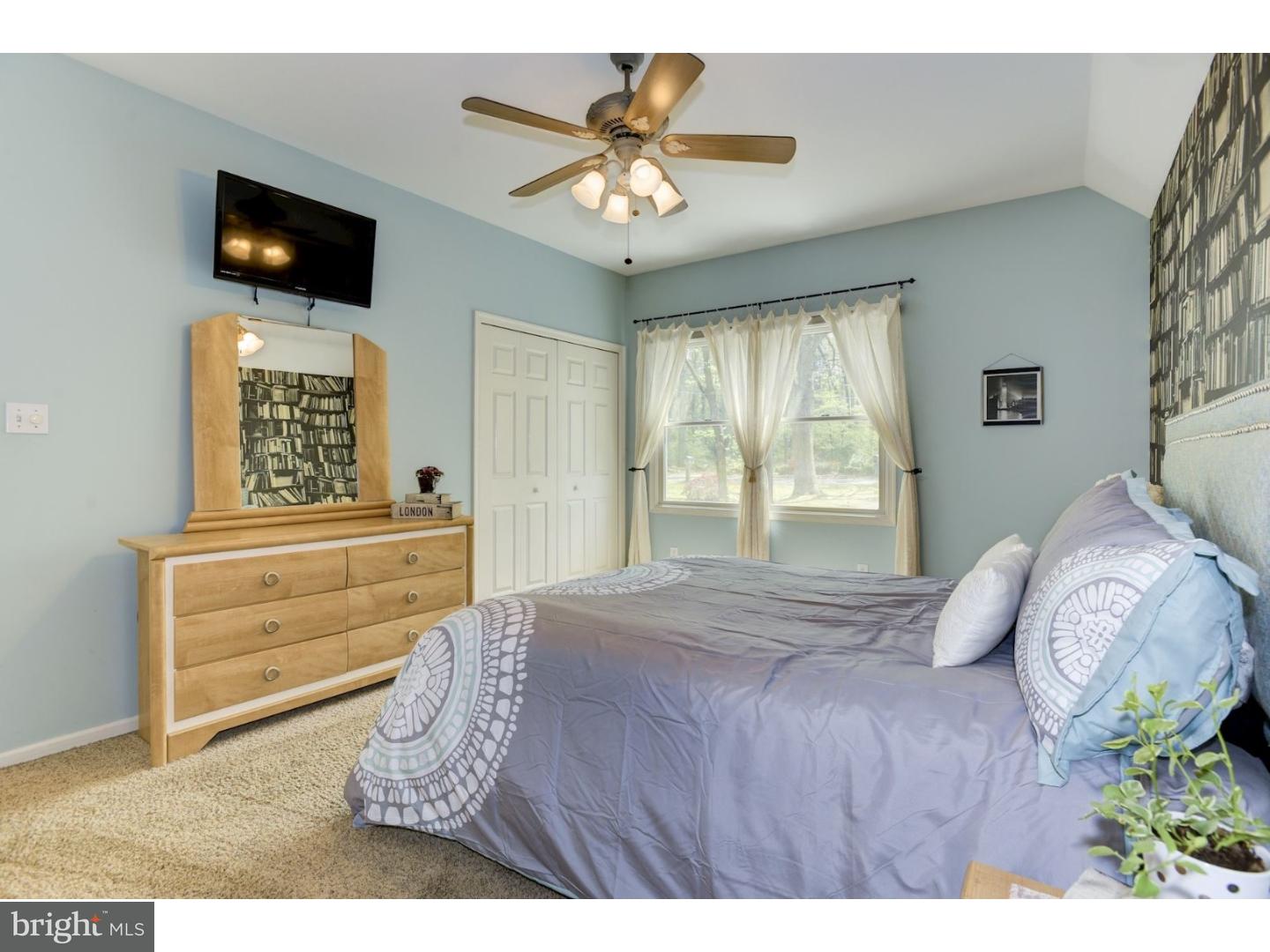 7 Lake Road Tabernacle, NJ 08088 - Photo 17 of 25 a bedroom with a bed a flat screen tv and a chandelier