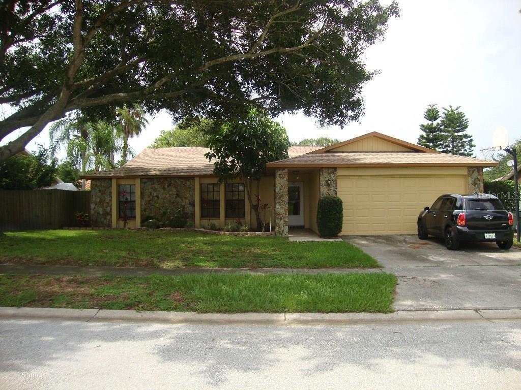 103 Timber Circle Safety Harbor, FL 34695 - Photo 1 of 1 a view of a white house next to a yard with big trees