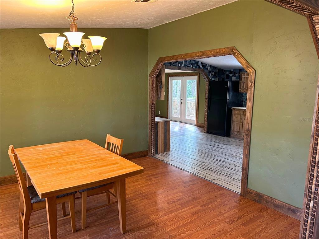 9867 Jerome Drive New Port Richey, FL 34654 - Photo 13 of 30 a view of a dining room with furniture and wooden floor