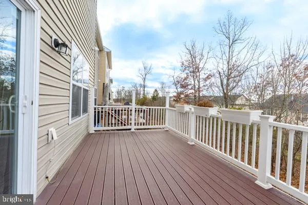 a view of a wooden deck with a yard