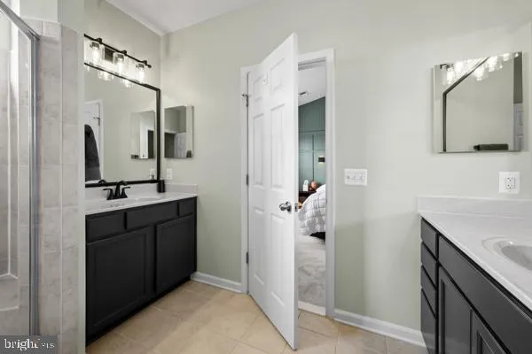 a bathroom with a double vanity sink mirror and shower