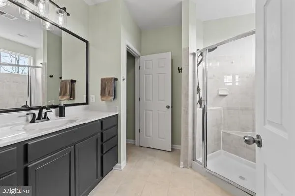 a bathroom with a double vanity sink mirror double and shower