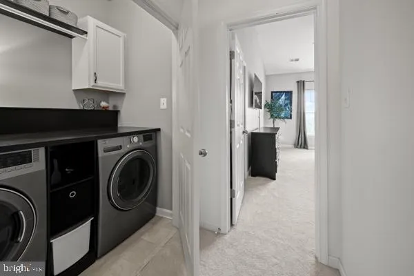 a view of a hallway with washer and dryer