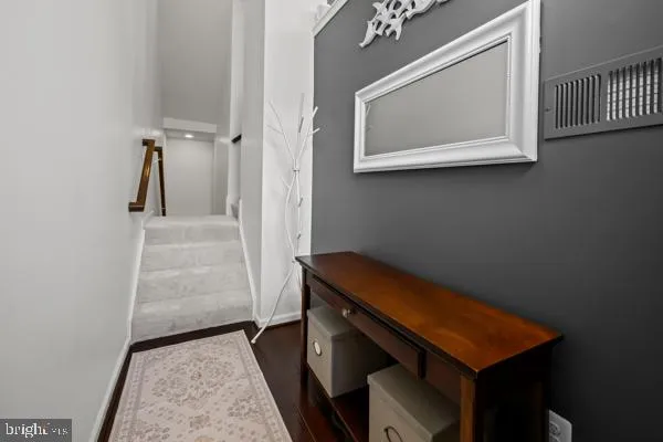 view of room with stairs and wooden floor