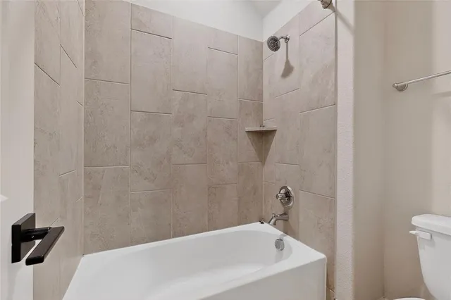 an empty room with ceiling fan and window