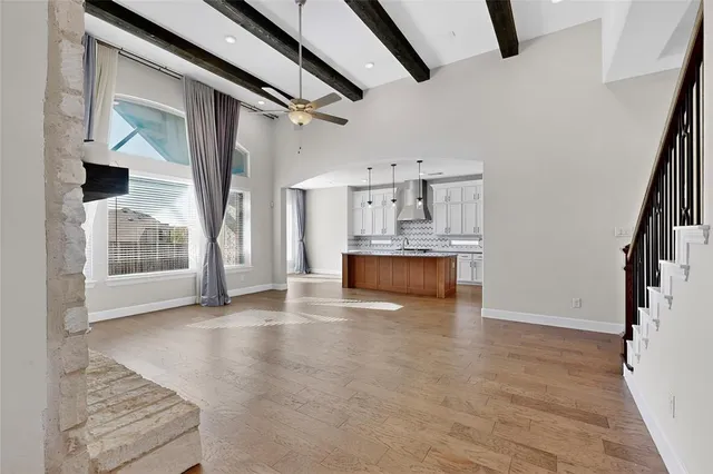 a view of kitchen and hall with wooden floor