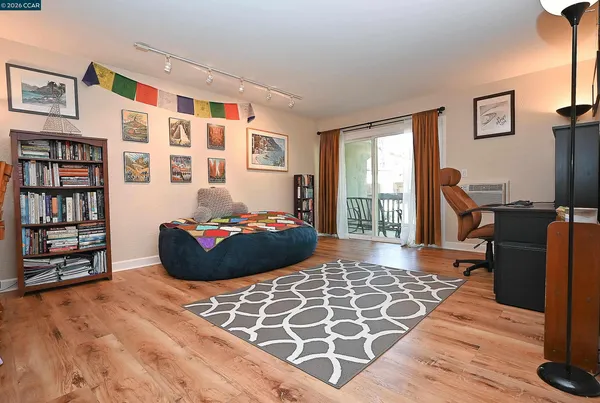 a bedroom with furniture and a book shelf