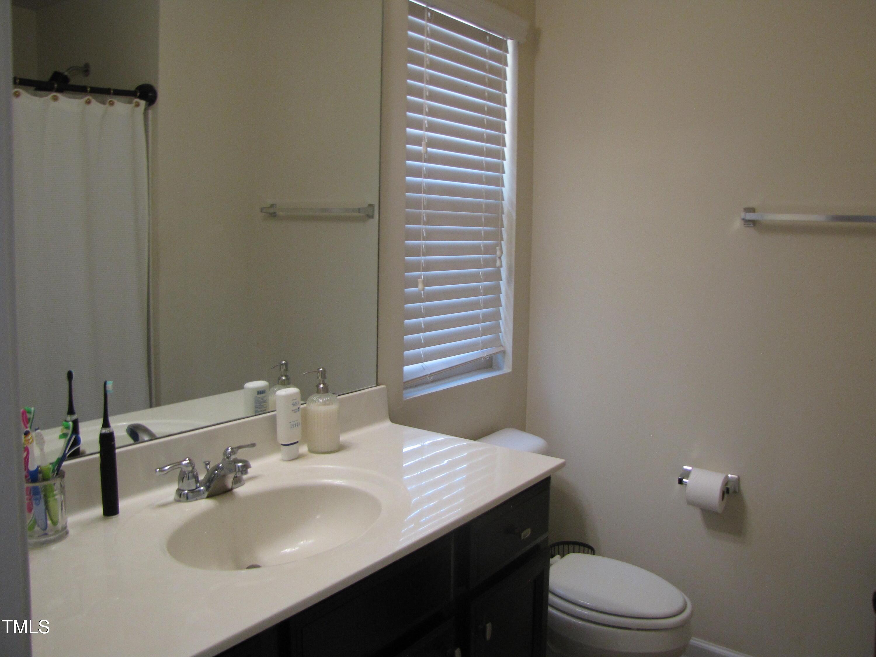 58 Pocono Drive Durham, NC 27705 - Photo 12 of 22 a bathroom with a sink toilet and a mirror