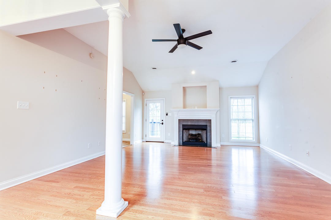 6068 Whisper Ridge Lane Corryton, TN 37721 - Photo 8 of 38 a view of empty room with wooden floor and fireplace