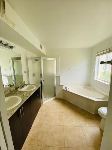 an empty room with a window and ceiling fan