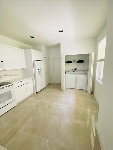 a room with a stove and a refrigerator