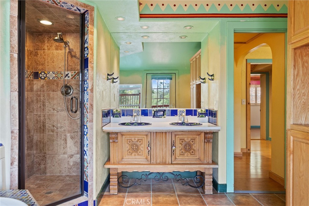 10294 Red Eye Road Oroville, CA 95965 - Photo 23 of 62 a bathroom with a sink a mirror and a shower