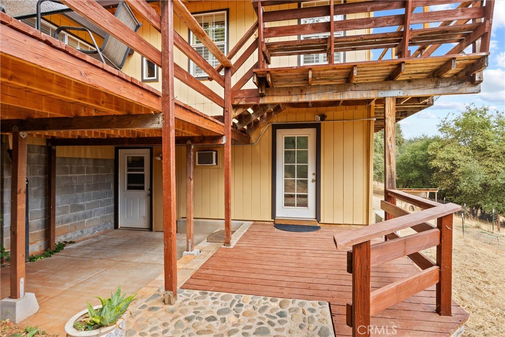 10294 Red Eye Road Oroville, CA 95965 - Photo 26 of 62 a view of a patio with table and chairs with wooden floor and fence