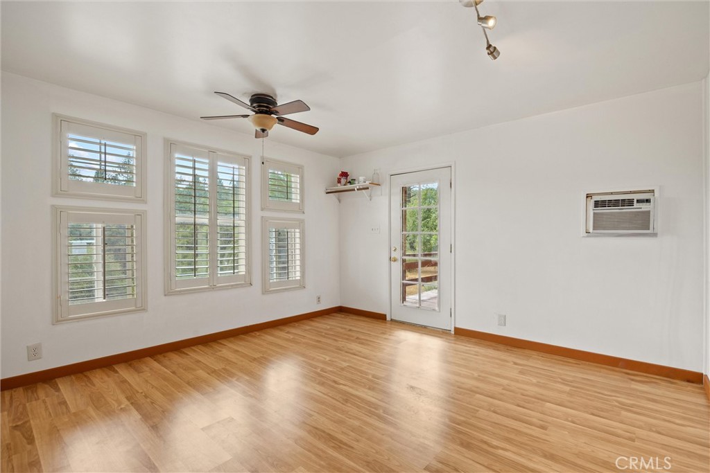 10294 Red Eye Road Oroville, CA 95965 - Photo 27 of 62 a view of an empty room with a window and wooden floor