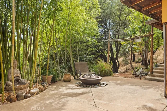 a view of a backyard with table and chairs and wooden fence