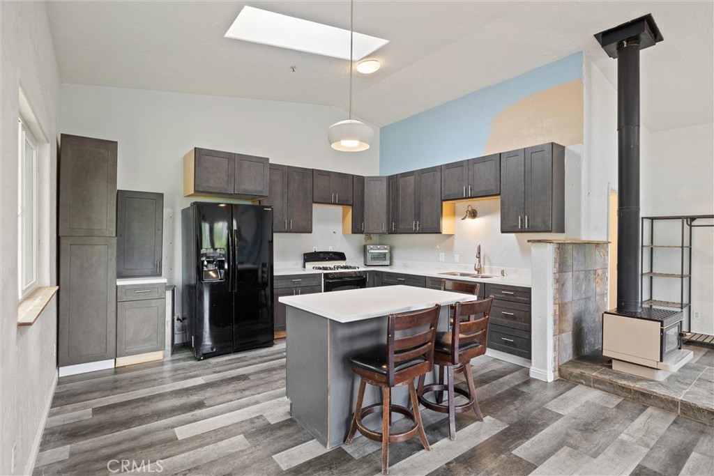 10294 Red Eye Road Oroville, CA 95965 - Photo 47 of 62 a kitchen with stainless steel appliances refrigerator stove microwave and cabinets