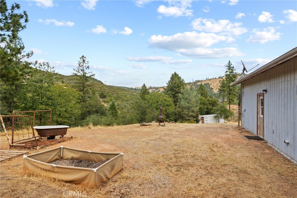 10294 Red Eye Road Oroville, CA 95965 - Photo 50 of 62 a view of a backyard with table and chairs and wooden fence