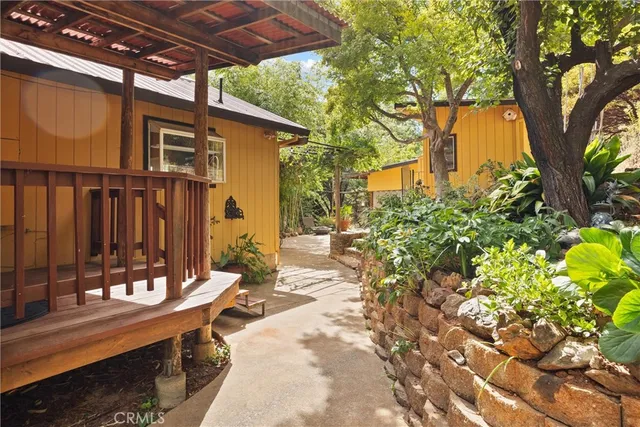 a patio with table and chairs and potted plants