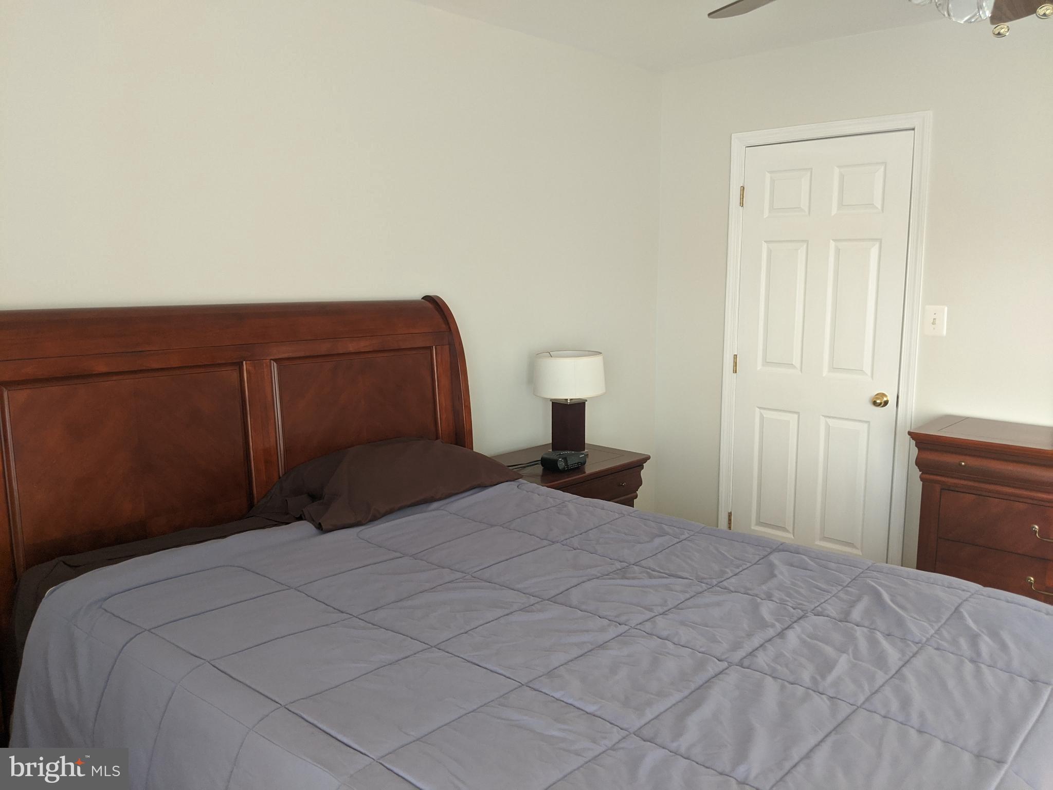 635 Waterloo Road, Unit 231 Warrenton, VA 20186 - Photo 27 of 32 Serene bedroom with warm wooden accents.