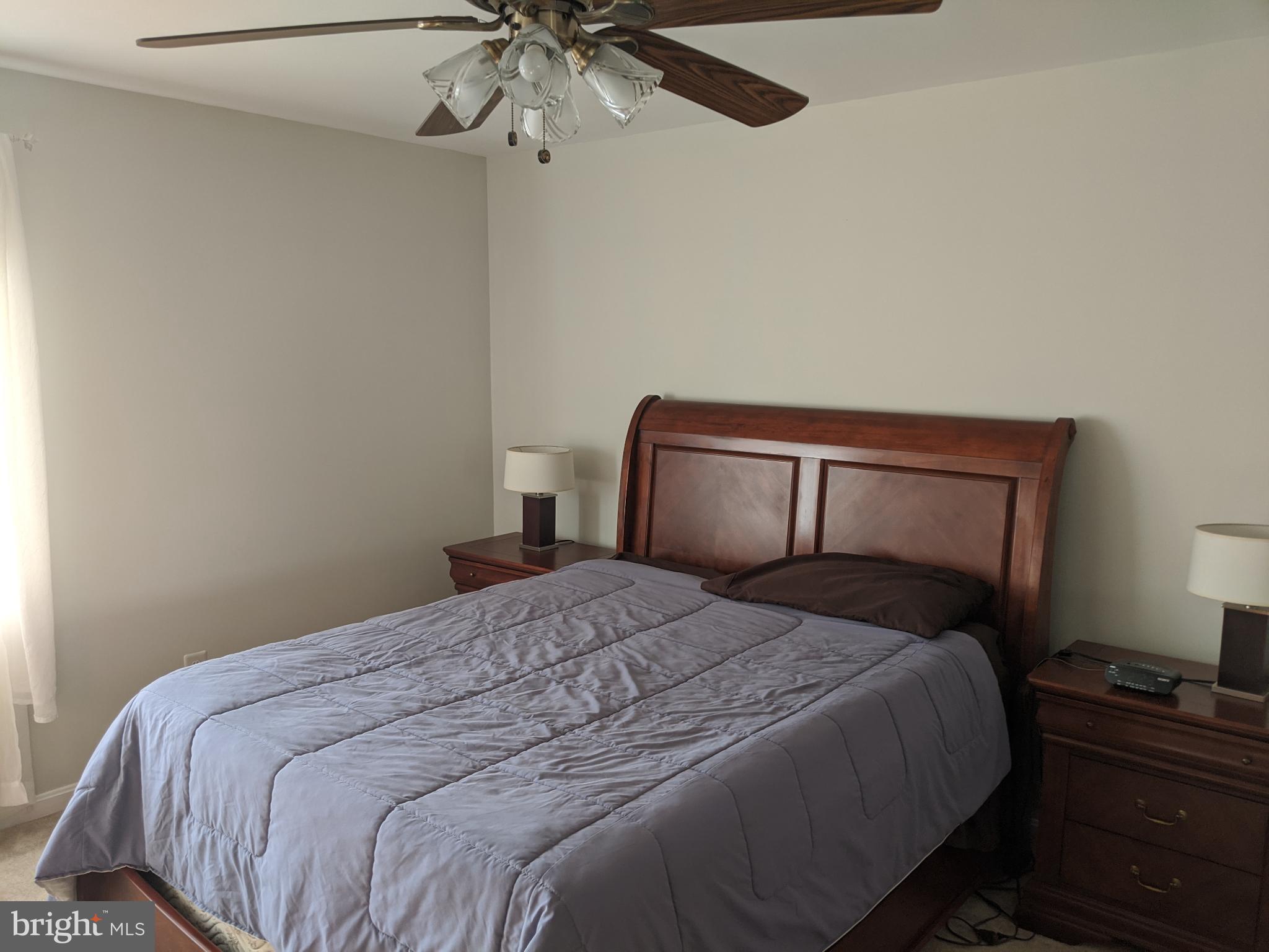 635 Waterloo Road, Unit 231 Warrenton, VA 20186 - Photo 6 of 32 Serene bedroom with warm wooden accents.