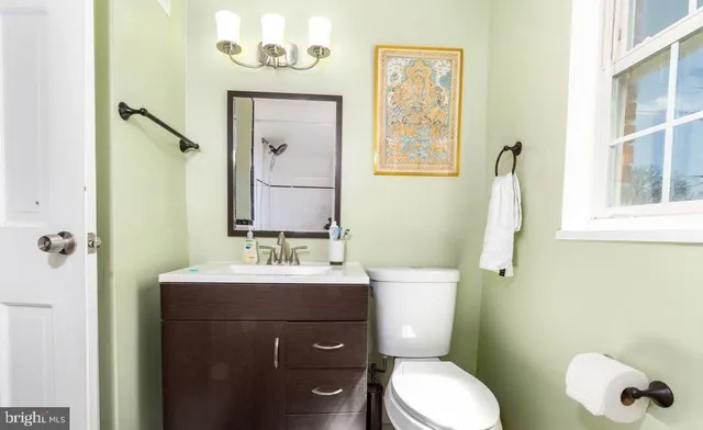 a bathroom with a toilet sink and mirror