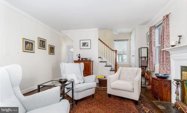 a living room with furniture a fireplace and a large mirror