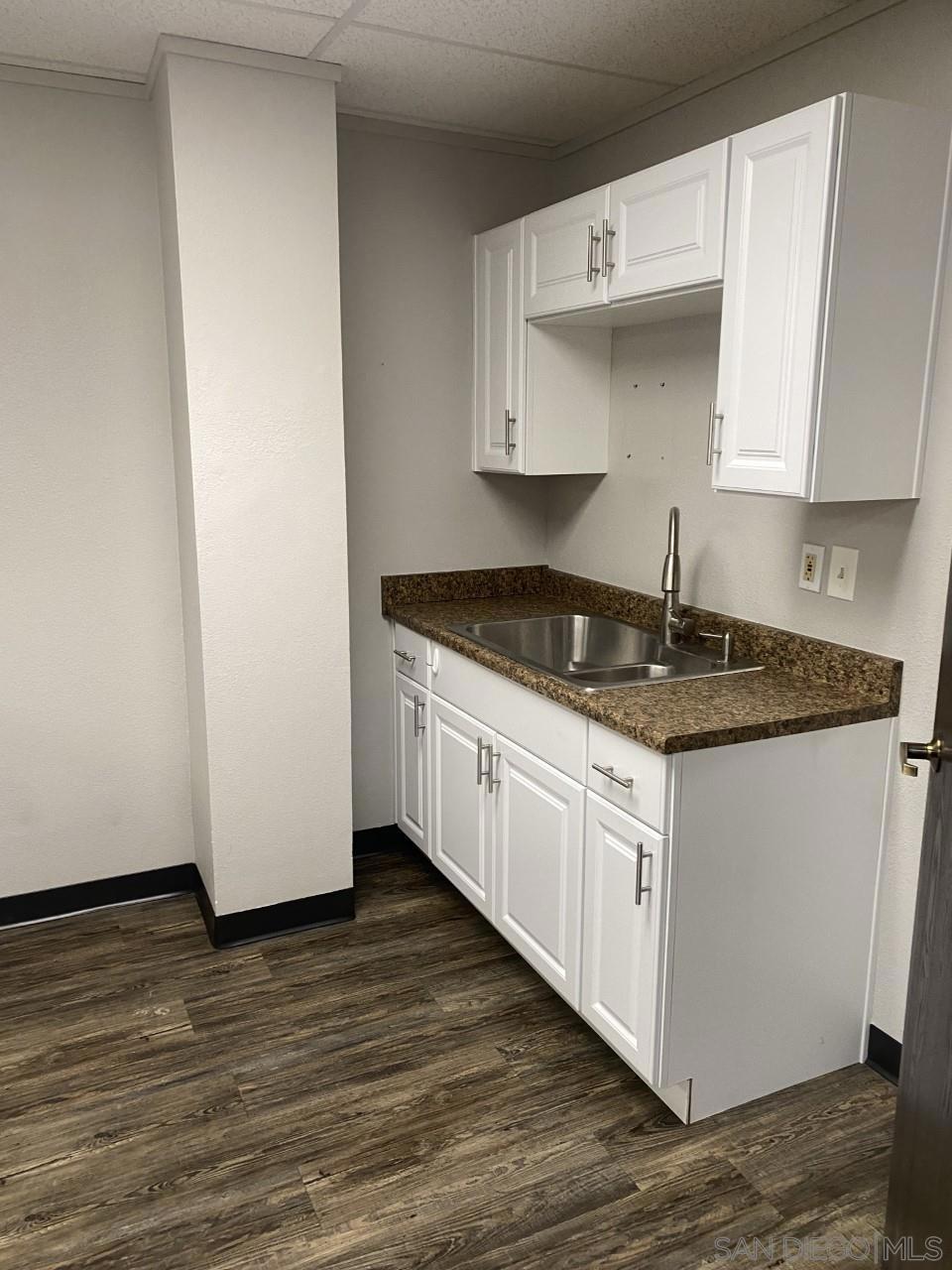 330 Rancheros Drive, Unit 258 San Marcos, CA 92069 - Photo 11 of 18 a kitchen with granite countertop white cabinets and a granite counter tops