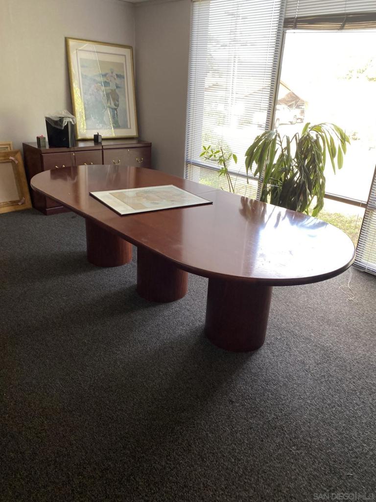 330 Rancheros Drive, Unit 258 San Marcos, CA 92069 - Photo 13 of 18 a room with a table chairs and wooden floor