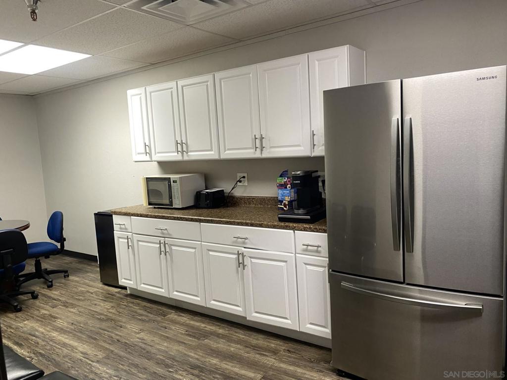 330 Rancheros Drive, Unit 258 San Marcos, CA 92069 - Photo 18 of 18 a kitchen with stainless steel appliances a refrigerator sink and cabinets
