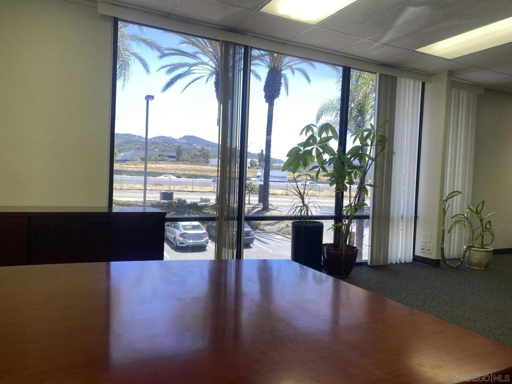 330 Rancheros Drive, Unit 258 San Marcos, CA 92069 - Photo 5 of 18 a living room with furniture wooden floor and a floor to ceiling window