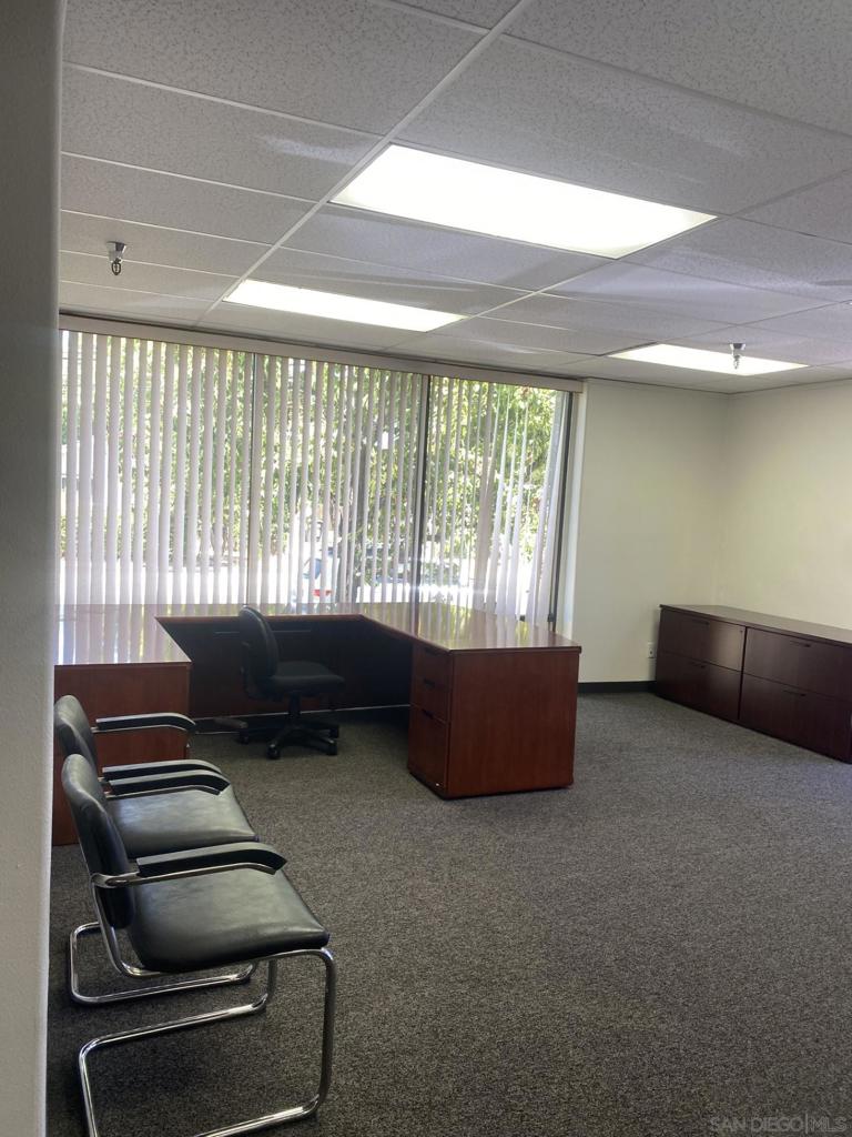 330 Rancheros Drive, Unit 258 San Marcos, CA 92069 - Photo 7 of 18 a living room with furniture and a floor to ceiling window