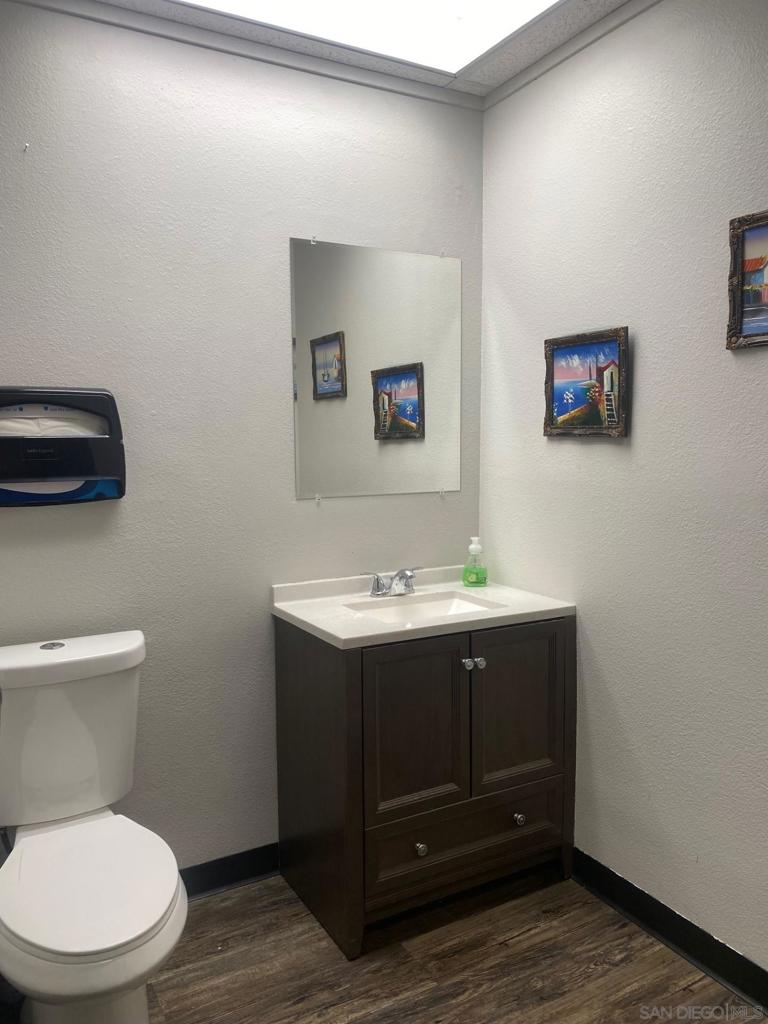 330 Rancheros Drive, Unit 258 San Marcos, CA 92069 - Photo 8 of 18 a bathroom with a toilet a sink and mirror