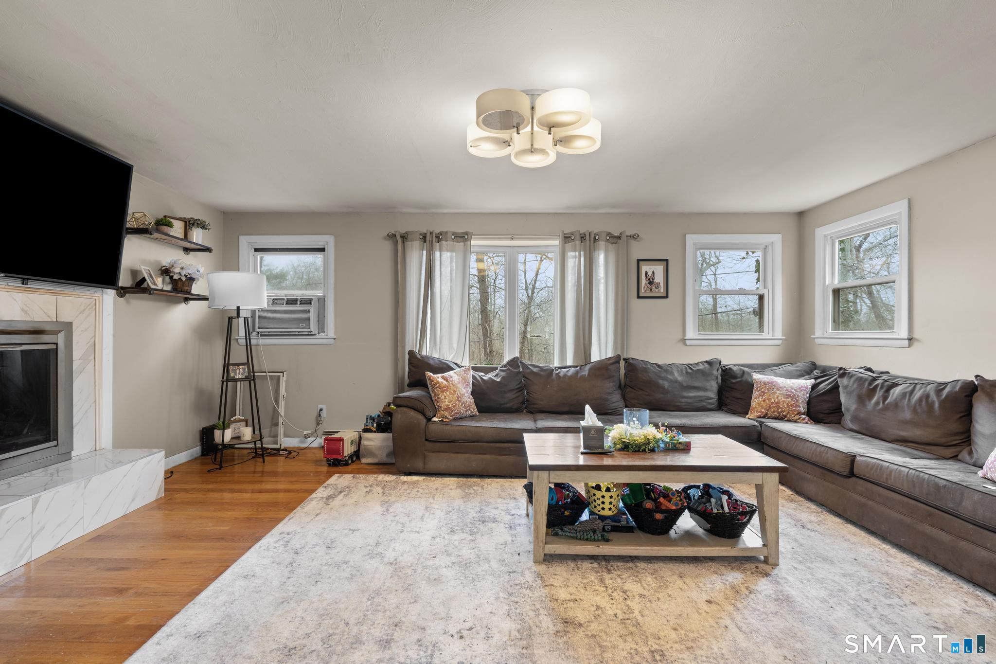 523 Chamberlain Hill Road Haddam, CT 06441 - Photo 16 of 40 a living room with furniture a flat screen tv and a window