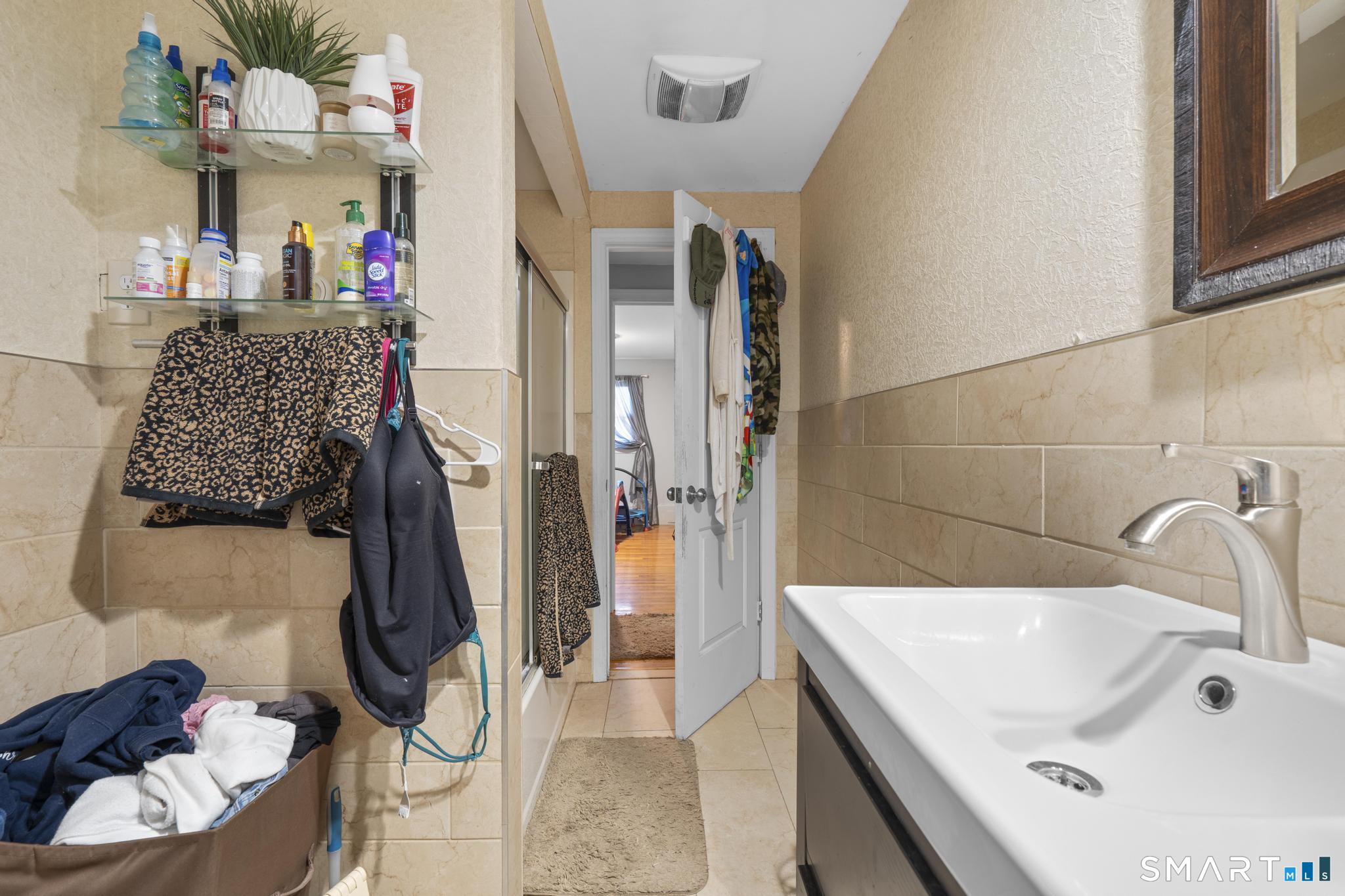 523 Chamberlain Hill Road Haddam, CT 06441 - Photo 26 of 40 a bathroom with a tub sink and shower curtain