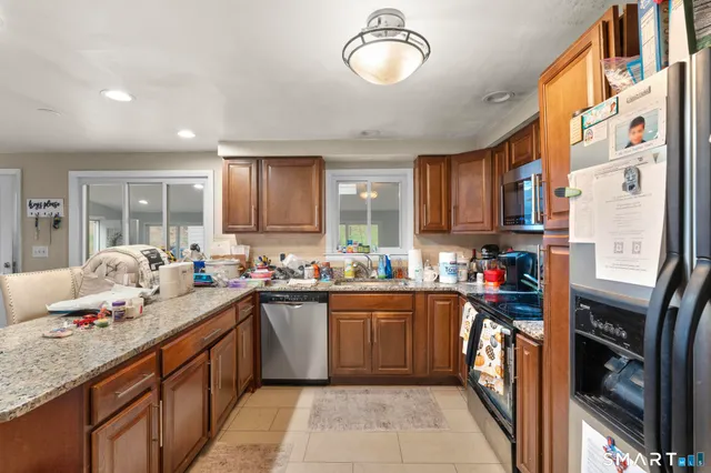 a kitchen with a sink a stove and cabinets