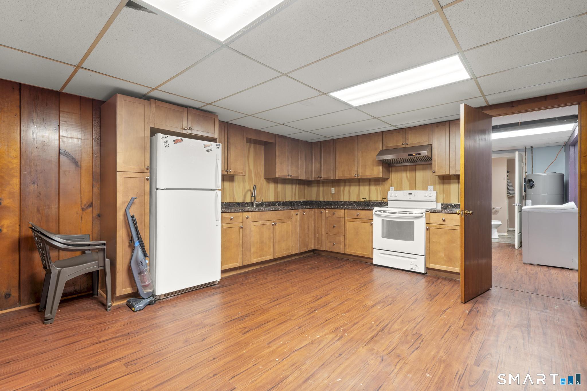 523 Chamberlain Hill Road Haddam, CT 06441 - Photo 32 of 40 a kitchen with granite countertop wooden floors and stainless steel appliances
