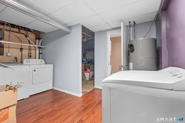 a bathroom with a granite countertop toilet and a shower