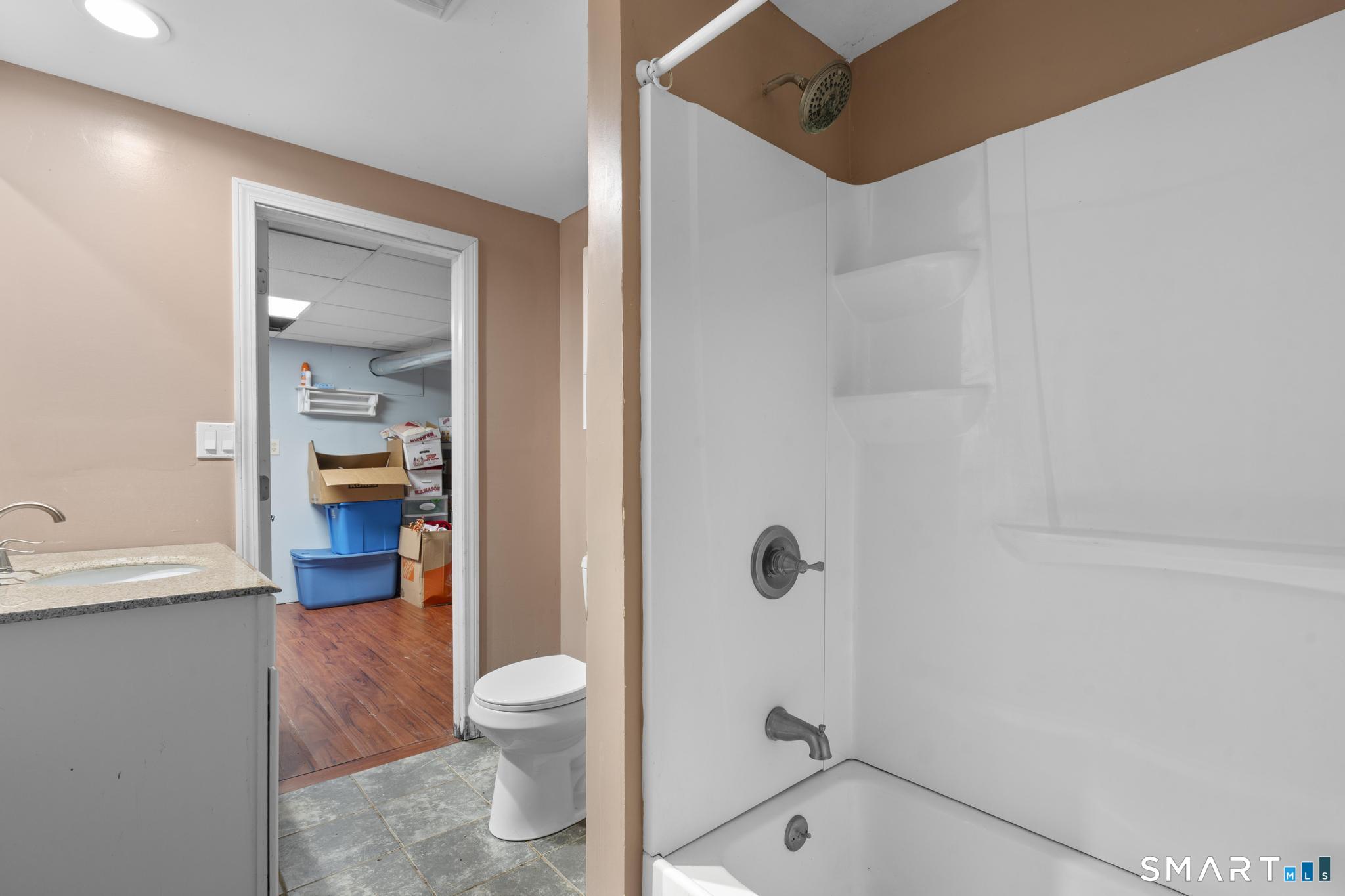 523 Chamberlain Hill Road Haddam, CT 06441 - Photo 37 of 40 a bathroom with a granite countertop toilet and a shower