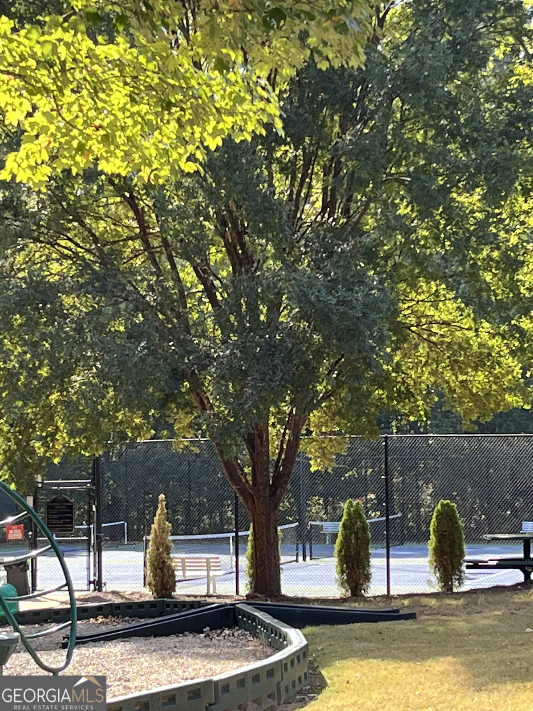 112 Granite Way Newnan, GA 30265 - Photo 20 of 22 a view of a house with garden and trees in the background