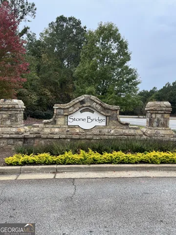 a view of a lake with a chair and table in the back