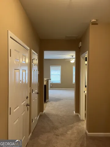 a kitchen with granite countertop a refrigerator stove and sink