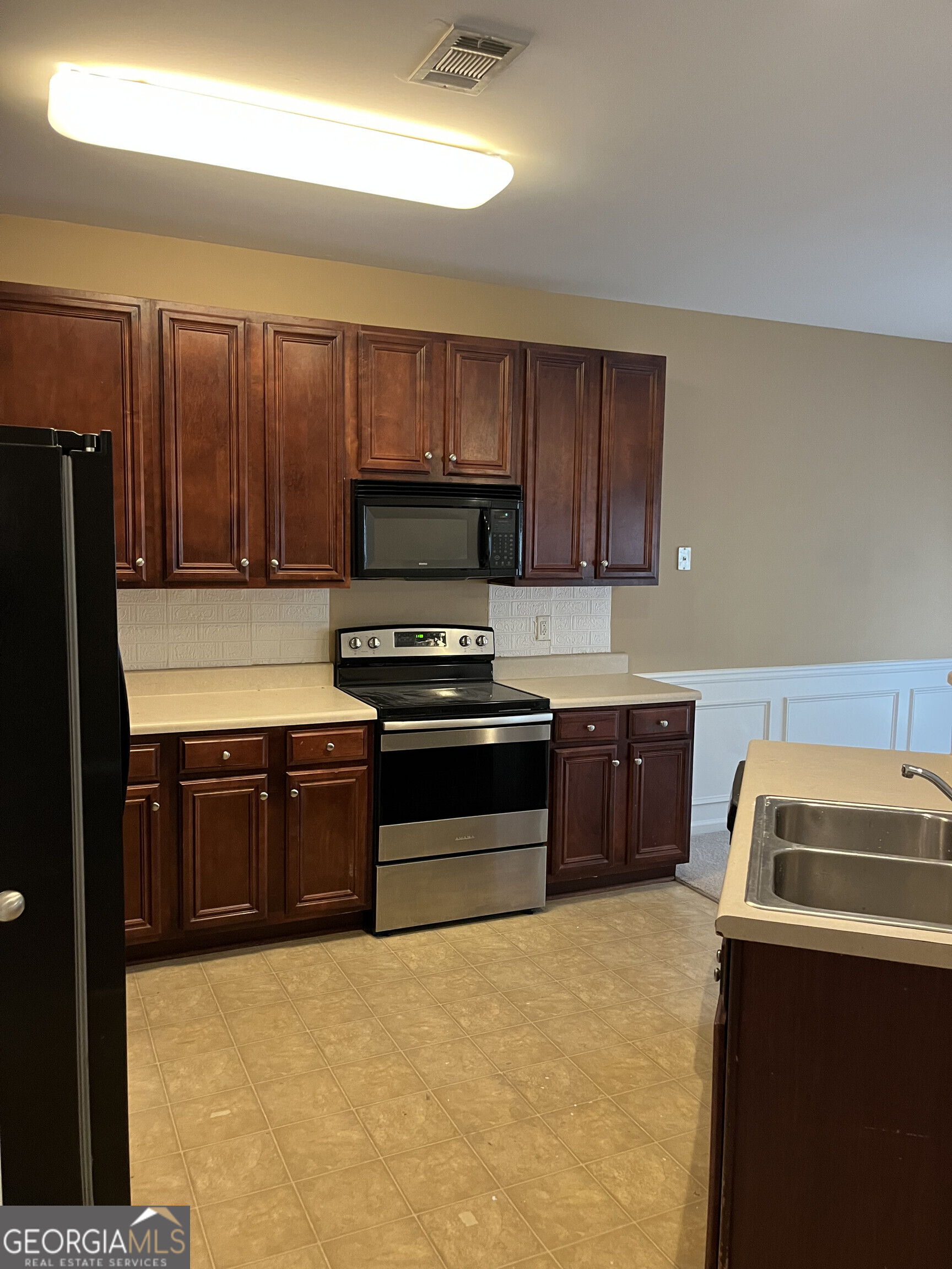 112 Granite Way Newnan, GA 30265 - Photo 4 of 22 a kitchen with granite countertop a refrigerator stove and sink