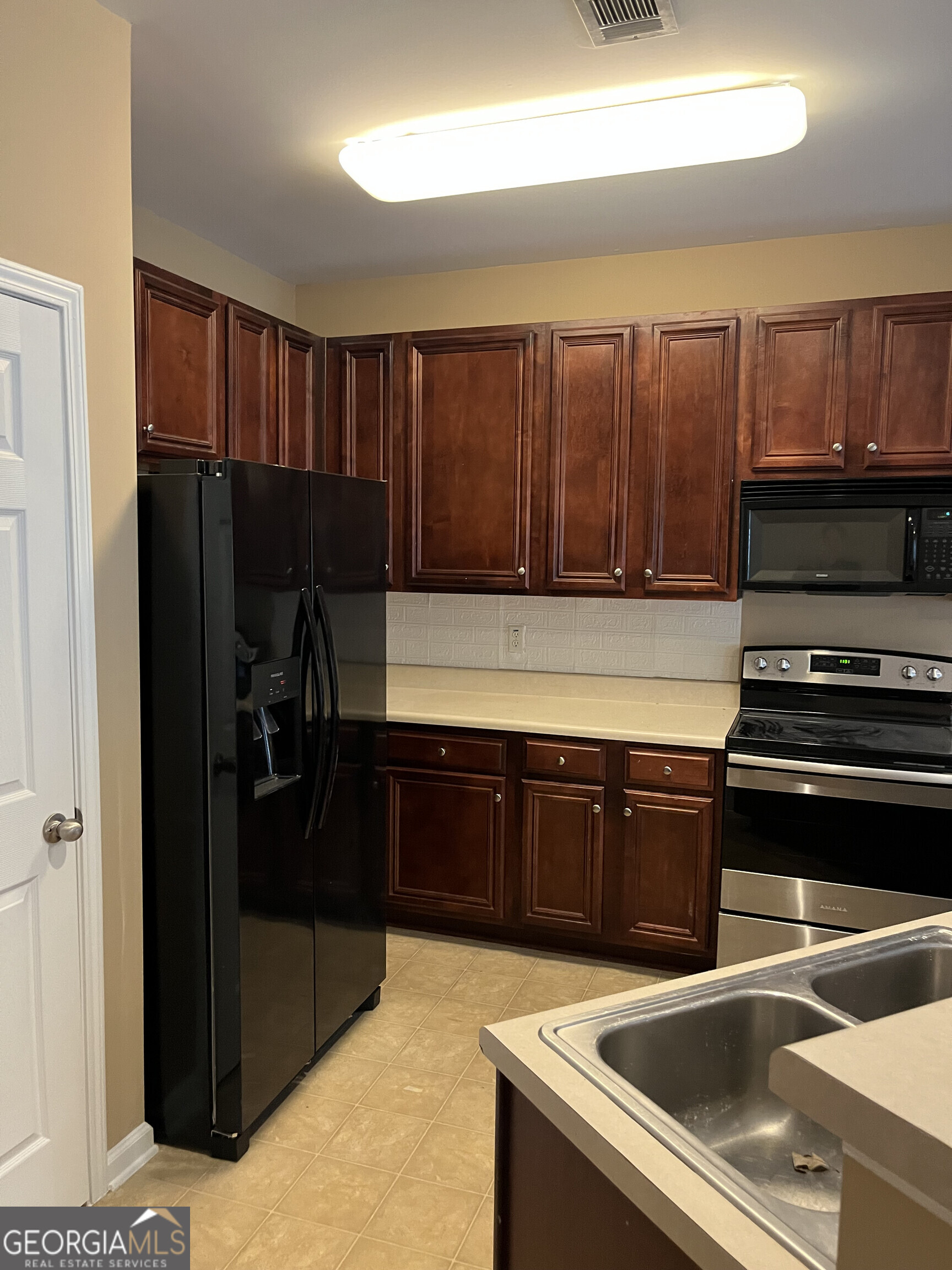 112 Granite Way Newnan, GA 30265 - Photo 6 of 22 a kitchen with a sink and a stove