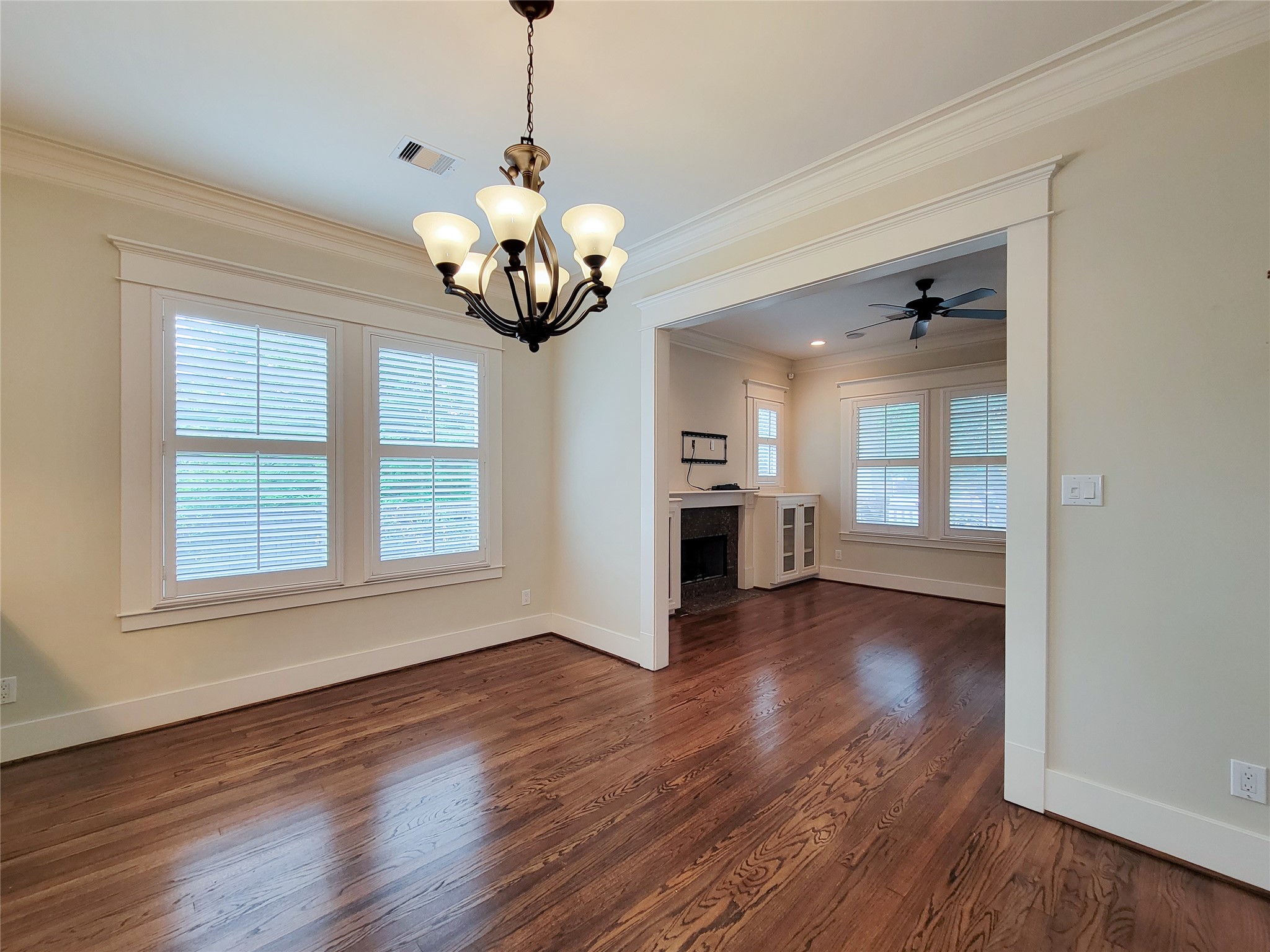 1140 West Cottage Street Houston, TX 77009 - Photo 10 of 37 a view of a room with wooden floor and a ceiling fan