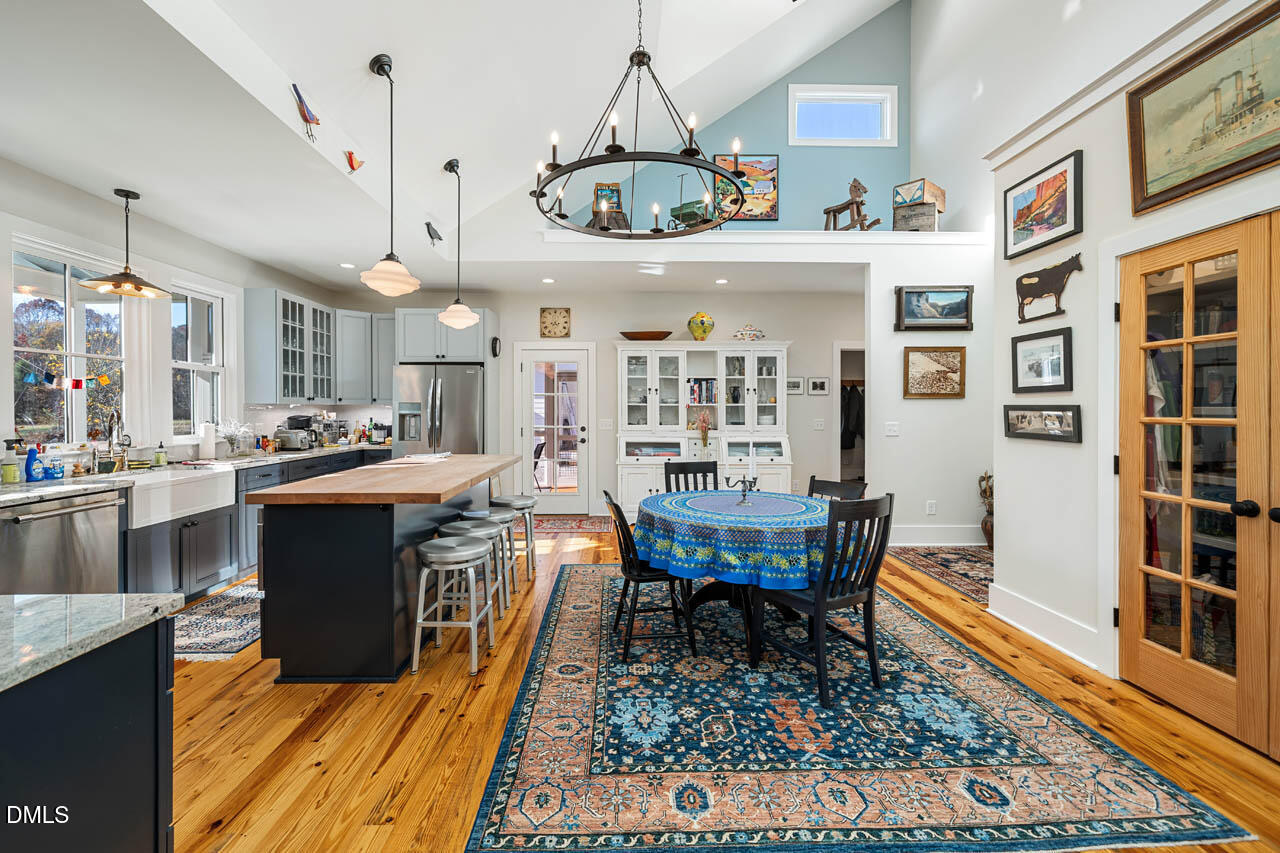 3833 Blakely Way Efland, NC 27243 - Photo 22 of 69 a kitchen with stainless steel appliances granite countertop a stove a sink a dining table and chairs