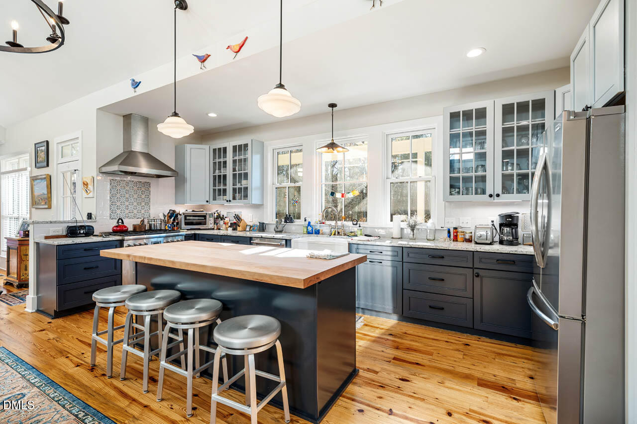 3833 Blakely Way Efland, NC 27243 - Photo 26 of 69 an open kitchen with granite countertop a sink and cabinets