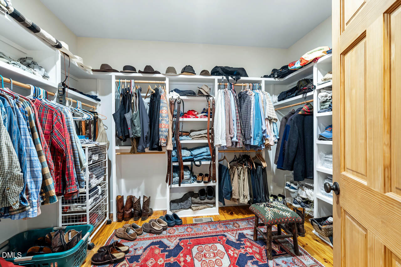 3833 Blakely Way Efland, NC 27243 - Photo 34 of 69 a view of walk in closet with clothes and shoes